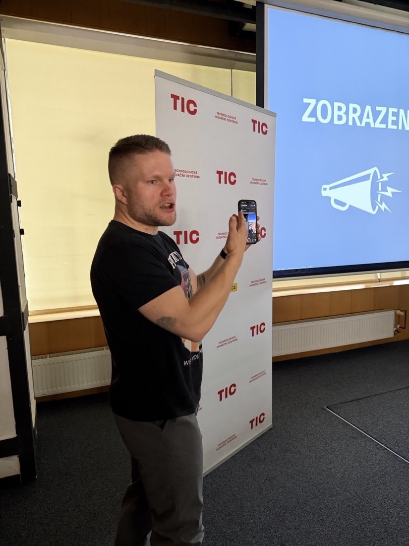 Luky před TIC bannerem s mobilem